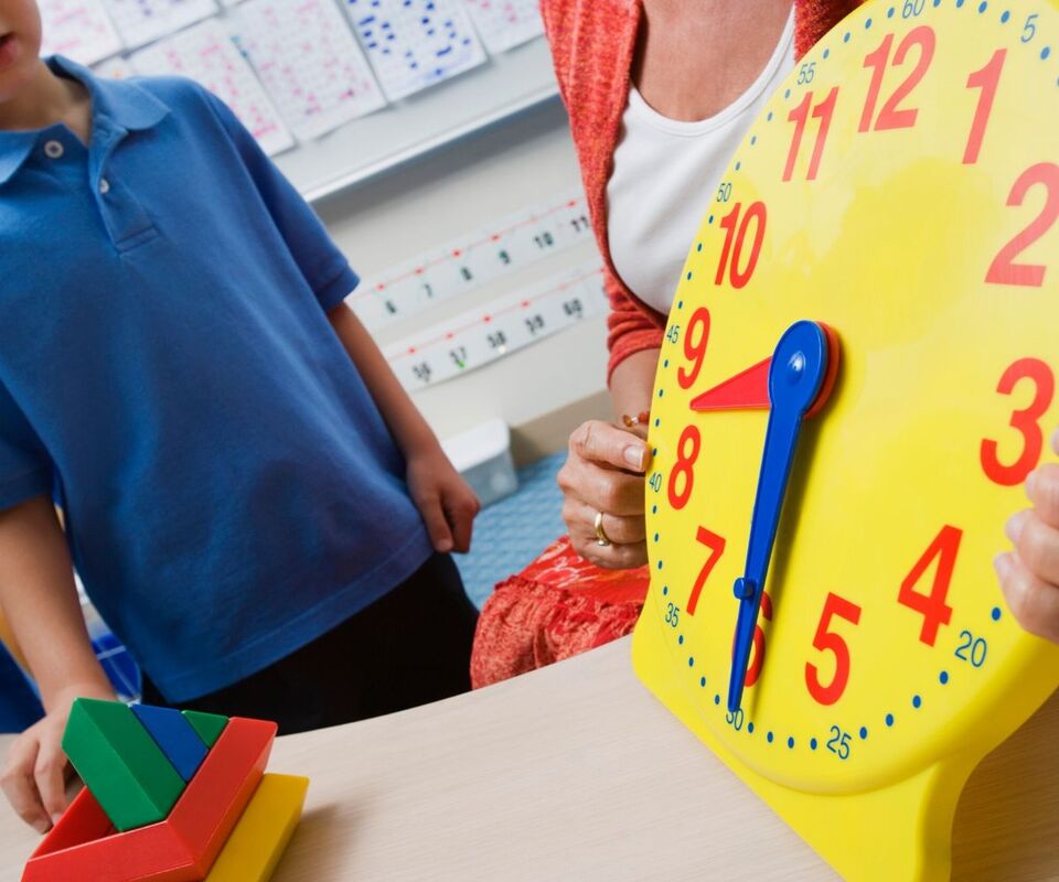 boy teacher learning how to tell time hands-on learning